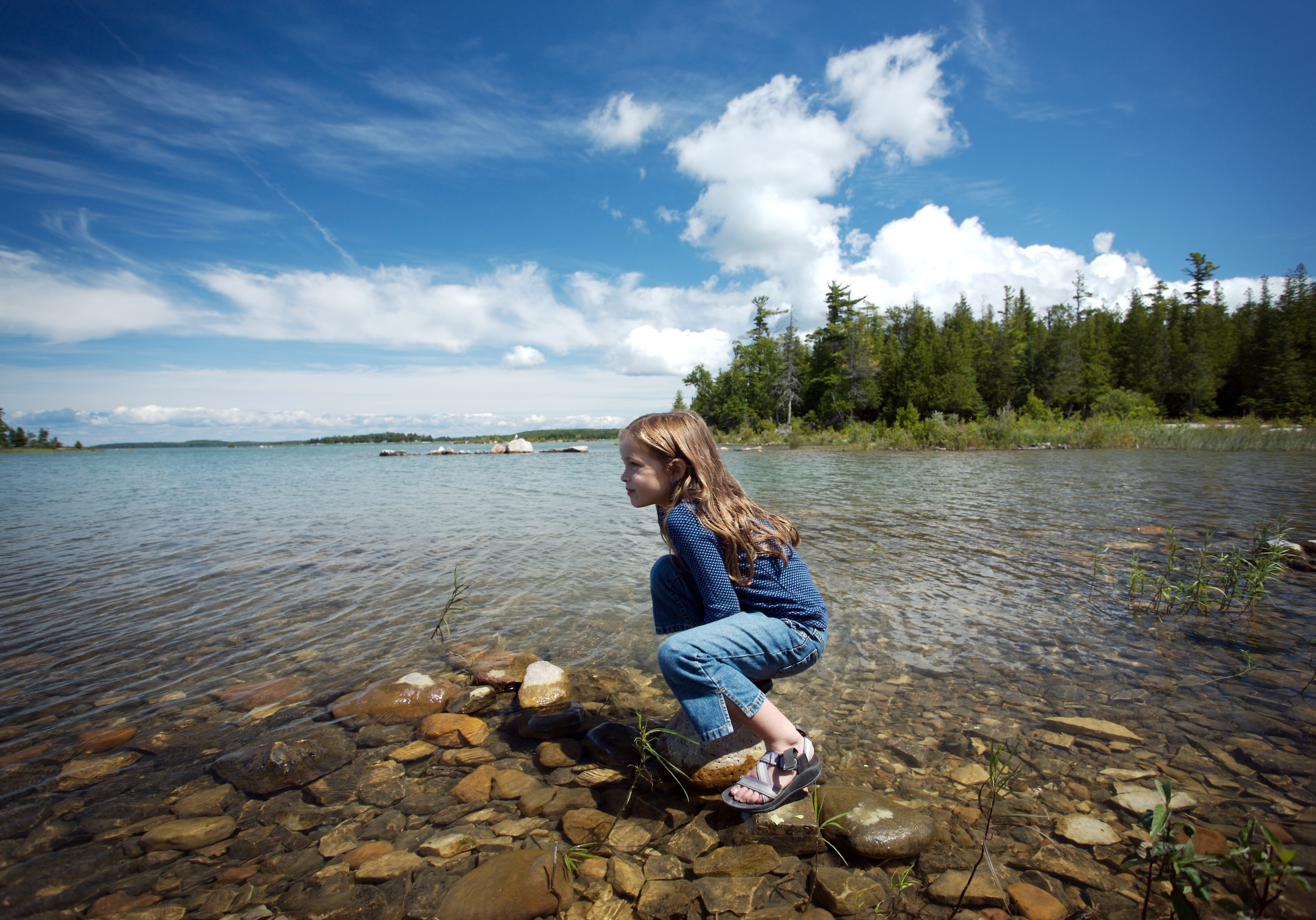 girl on a rock in lake michigan