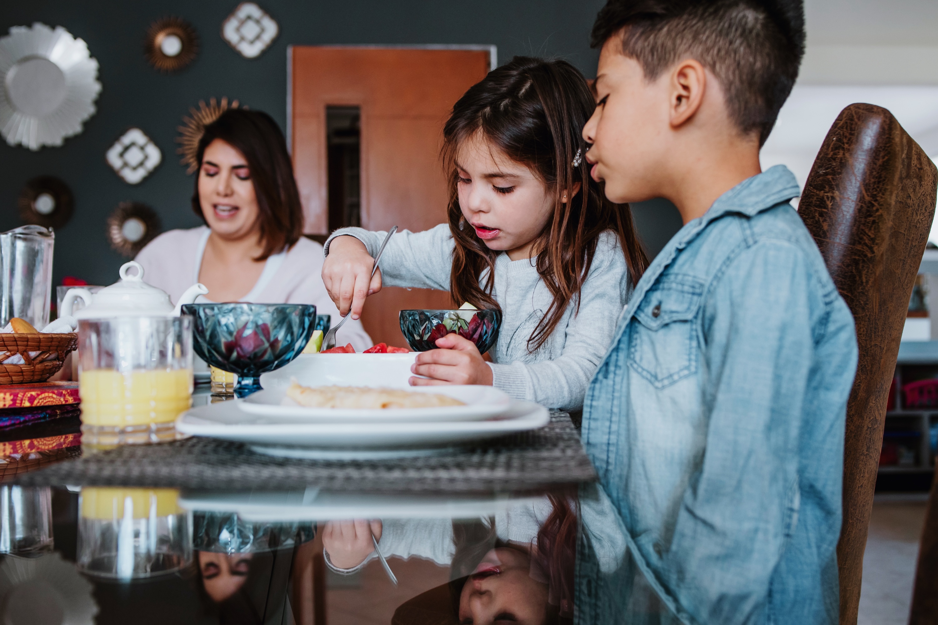 latin family son and daughter having breakfast