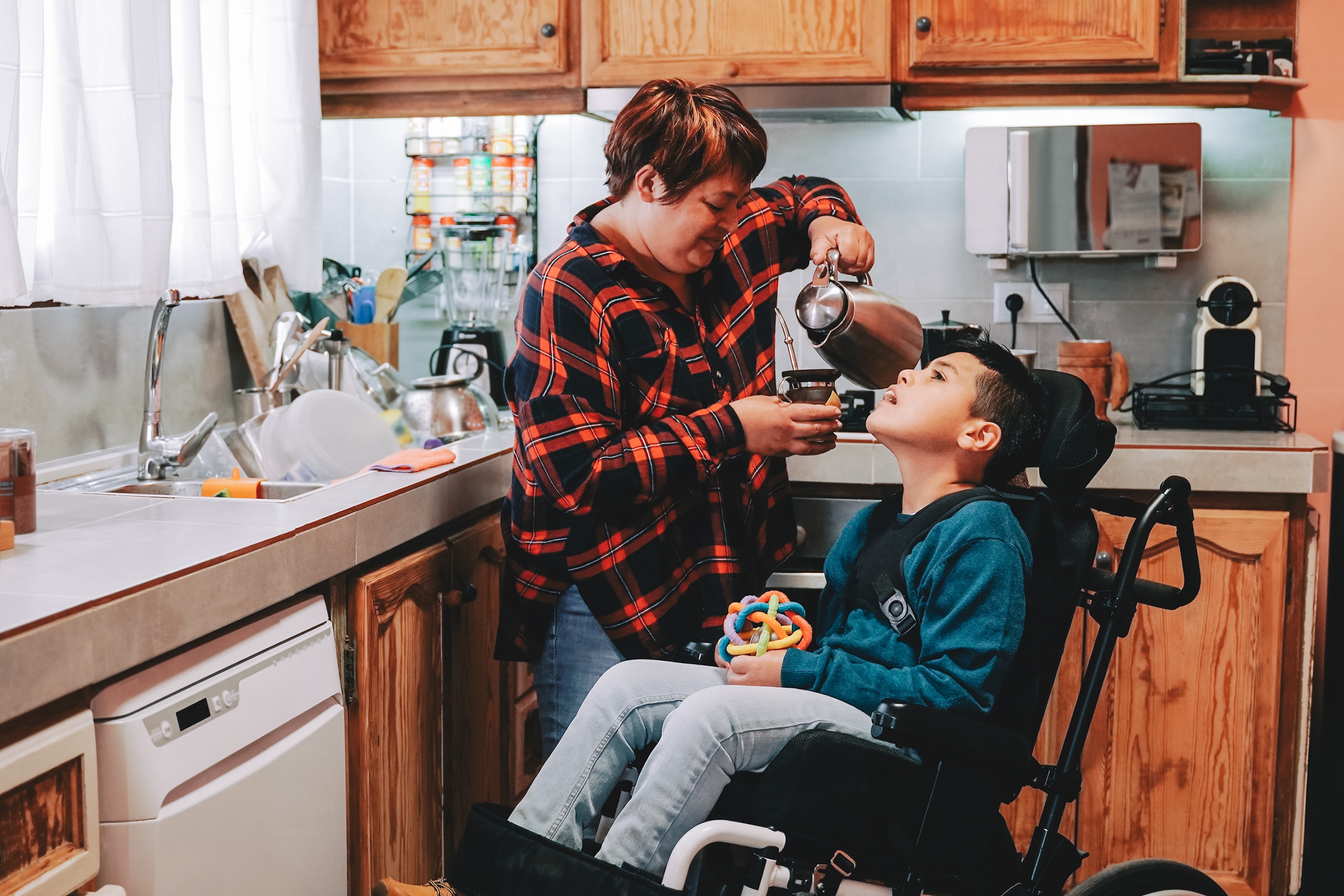 latin mother taking care of son with disability