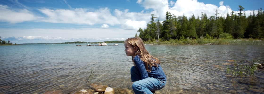 girl on a rock in lake michigan