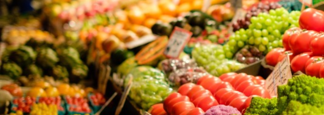 a row of colorful fruits and vegetables in a grocery store