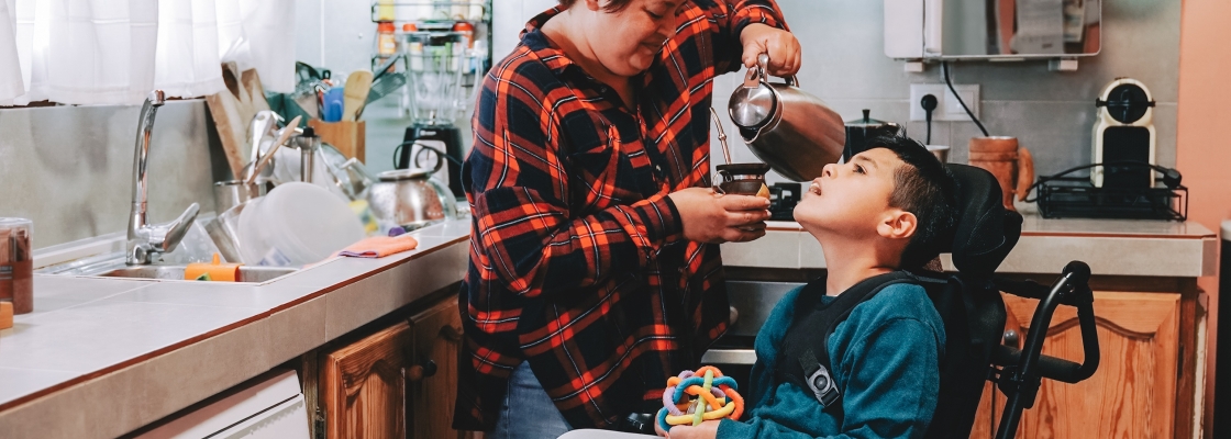 latin mother taking care of son with disability